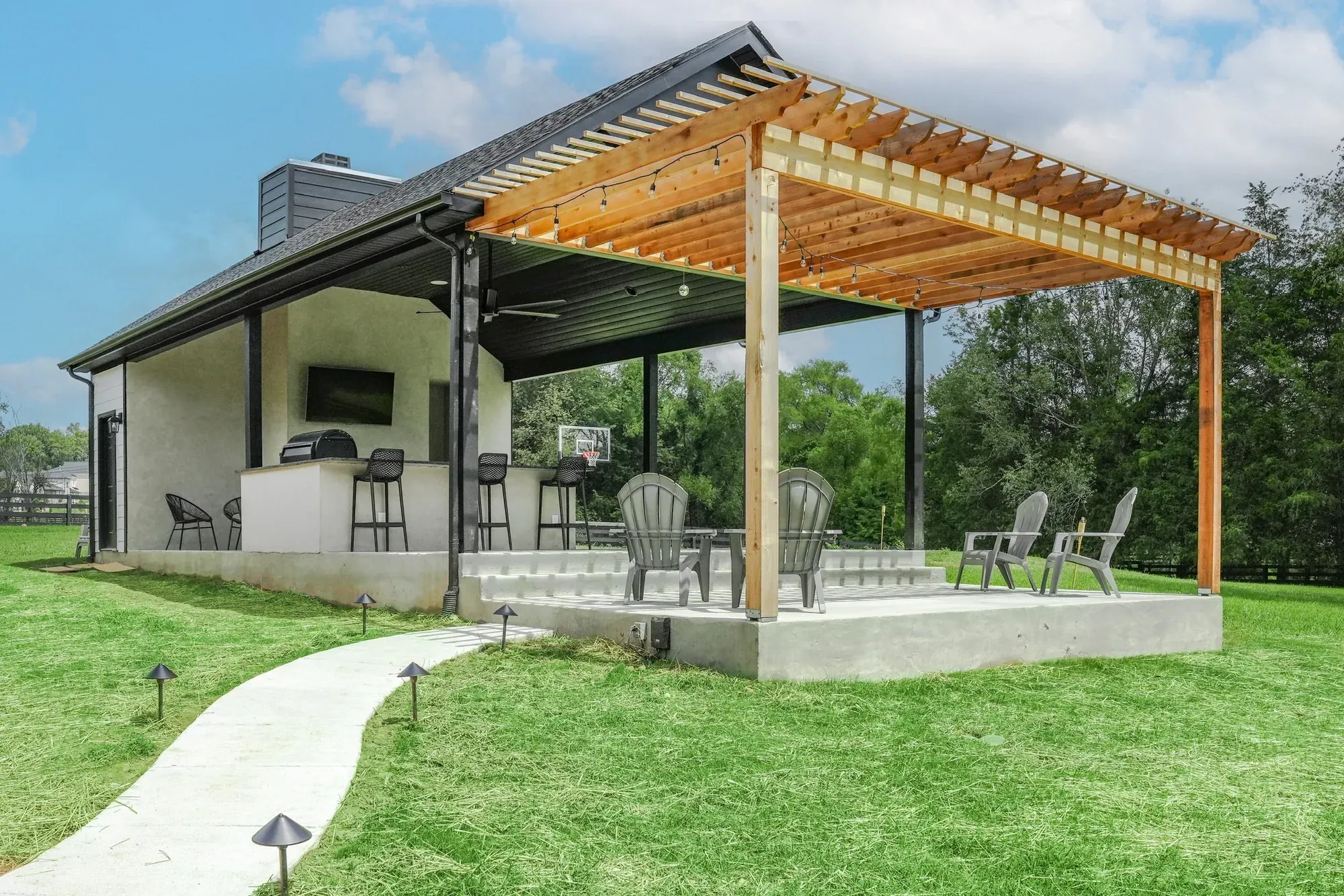 Backyard pavilion with a cedar pergola and outdoor kitchen built by Southern Belle Construction in Middle Tennessee